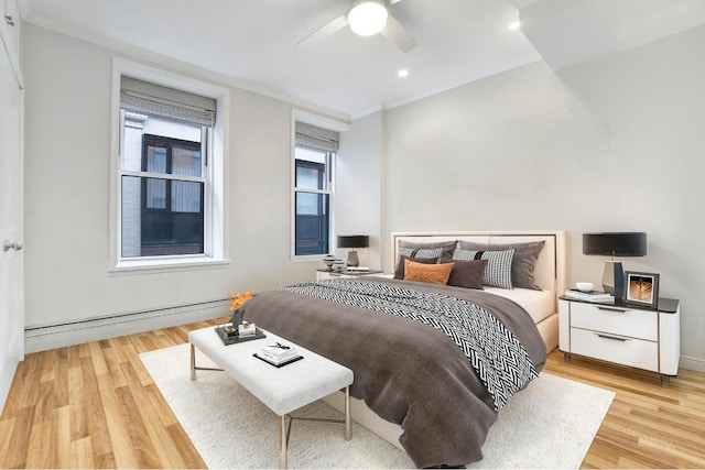 bedroom featuring a baseboard radiator, ornamental molding, ceiling fan, and light hardwood / wood-style flooring