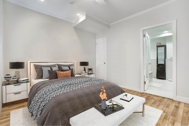 bedroom featuring ornamental molding, connected bathroom, and light hardwood / wood-style flooring