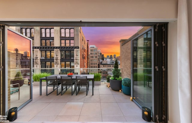balcony with a city view and outdoor dining space