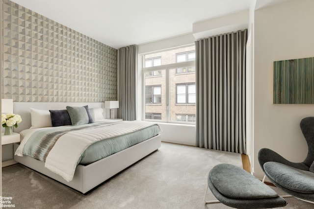 bedroom with wallpapered walls and carpet