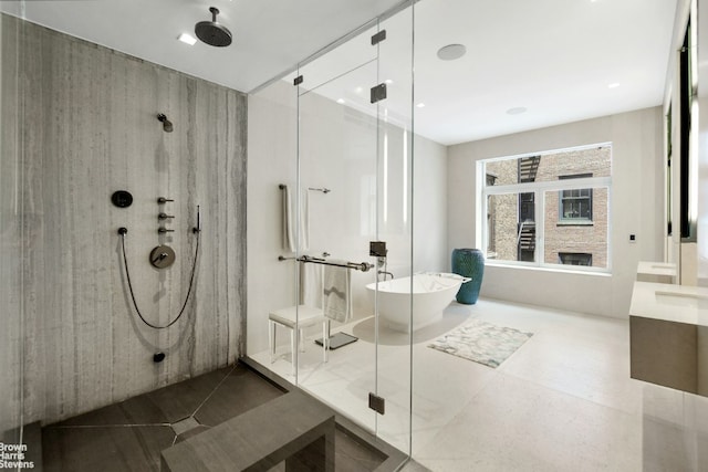 bathroom featuring plus walk in shower and vanity