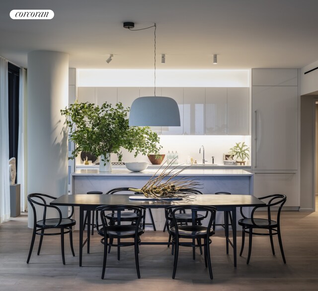 dining space with sink and hardwood / wood-style flooring