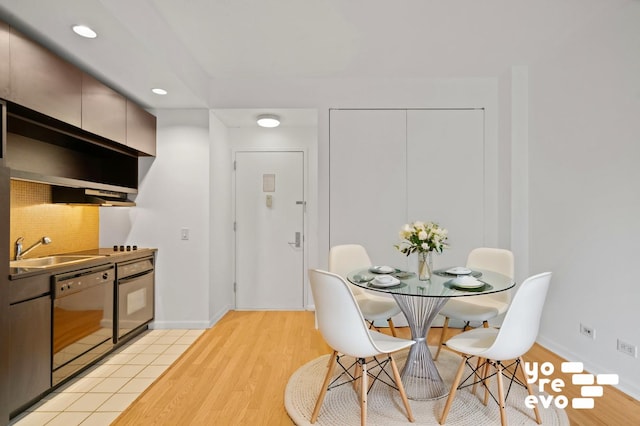 dining area with baseboards, recessed lighting, and light wood-style floors