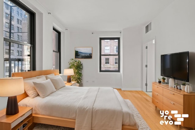 bedroom featuring visible vents and light wood-style floors