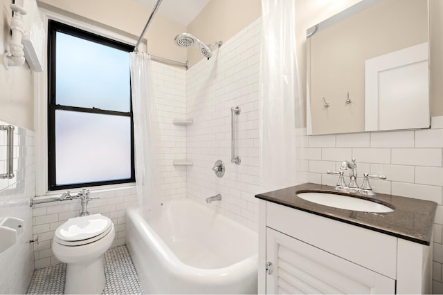 full bathroom featuring toilet, shower / tub combo, vanity, and tile walls