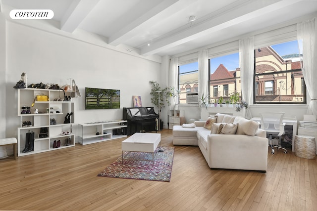 living room featuring hardwood / wood-style flooring, beamed ceiling, and visible vents