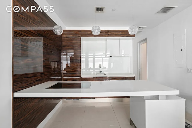 111 Fulton St Unit Ph103, New York City, NY 10038 - kitchen with electric panel, hanging light fixtures, tile patterned flooring, modern cabinets, and white cabinets