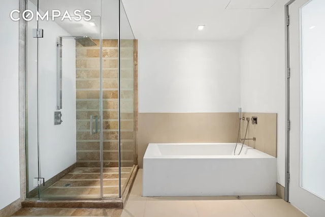 111 Fulton St Unit Ph103, New York City, NY 10038 - full bathroom featuring a bath, a stall shower, and tile patterned flooring