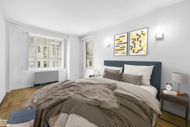 bedroom featuring baseboards and radiator heating unit