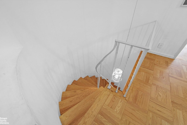 staircase featuring baseboards