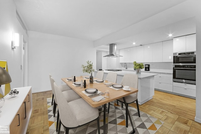 dining area with light parquet flooring and sink