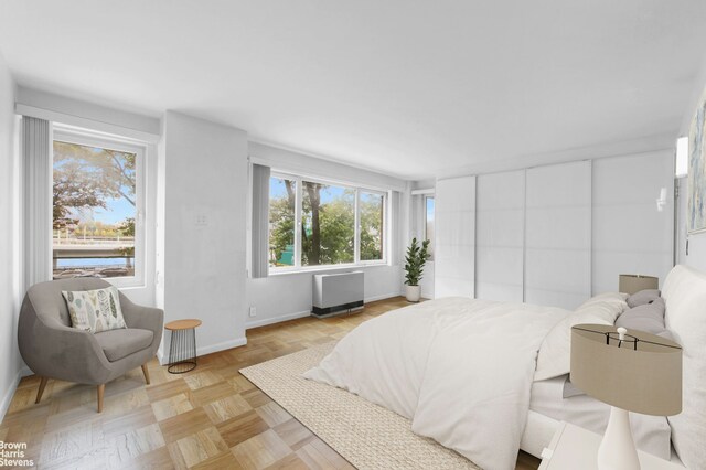 bedroom featuring parquet flooring and radiator heating unit