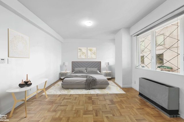 bedroom featuring baseboards and radiator