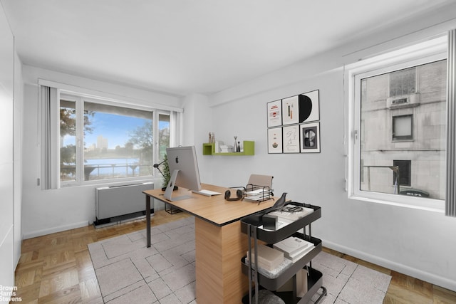 office featuring radiator heating unit and baseboards