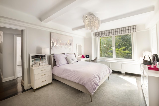 bedroom with beam ceiling and an inviting chandelier