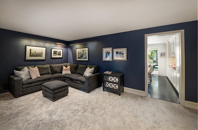 carpeted living room featuring baseboards