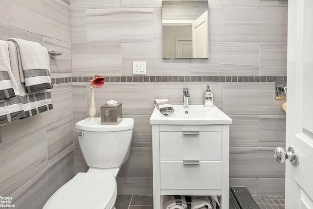 311 E 75th St Unit 3H, New York City, NY 10021 - bathroom with toilet, vanity, and tile walls