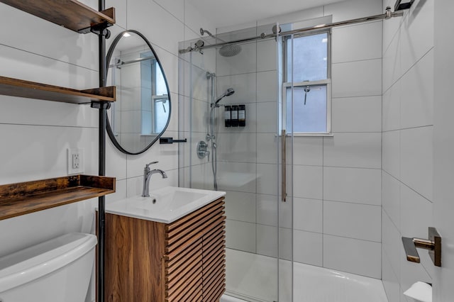 full bath featuring vanity, a shower stall, toilet, and tile walls