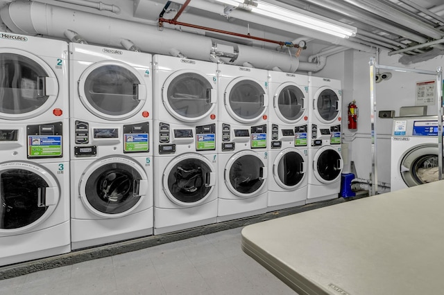 common laundry area featuring washer and clothes dryer and stacked washer / dryer