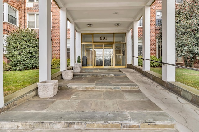 doorway to property with brick siding