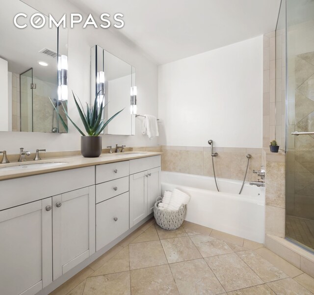 bathroom with vanity, tile patterned floors, and shower with separate bathtub