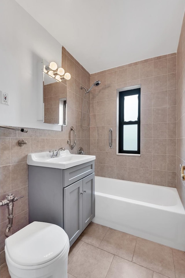 full bathroom featuring tile walls, toilet, vanity,  shower combination, and tile patterned floors