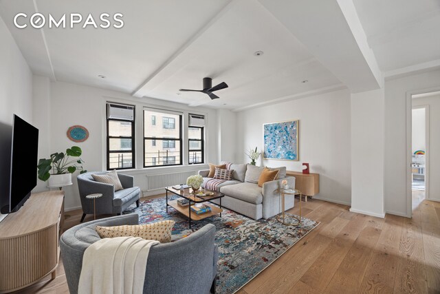 living room featuring light hardwood / wood-style flooring and ceiling fan