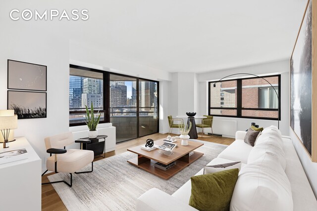 240 E 47th St Unit 27A, New York City, NY 10017 - living room with wood finished floors and a view of city