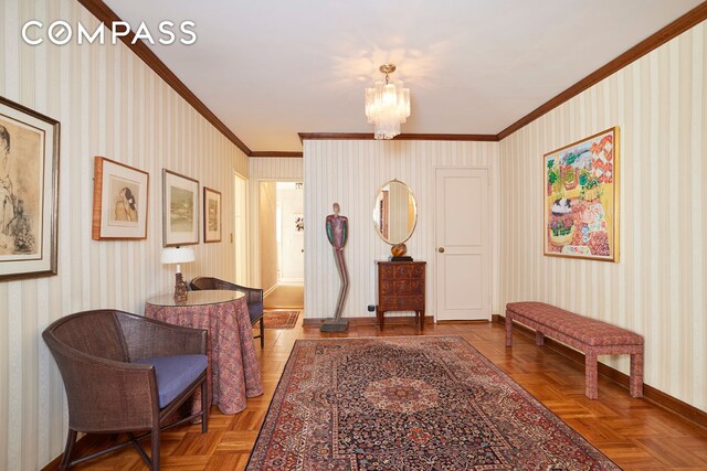 living area featuring ornamental molding, parquet flooring, and an inviting chandelier