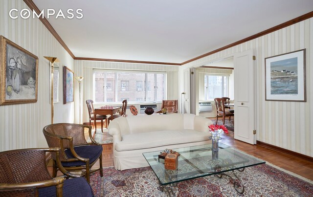 living room with ornamental molding and parquet floors