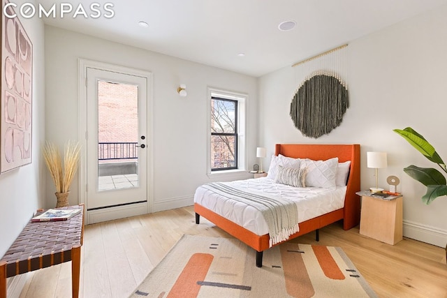 bedroom with wood-type flooring and access to outside