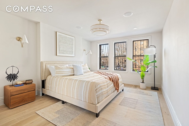 bedroom featuring baseboards and light wood finished floors