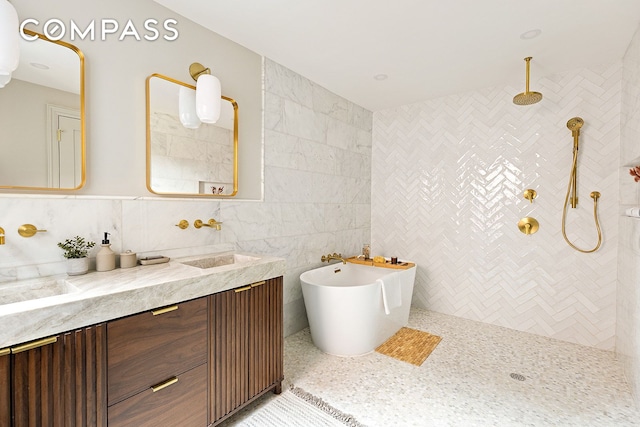 bathroom with a soaking tub, tile walls, tiled shower, and vanity