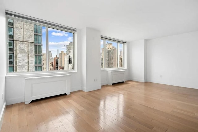 spare room with light hardwood / wood-style flooring