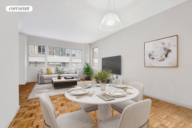 dining space with light parquet floors