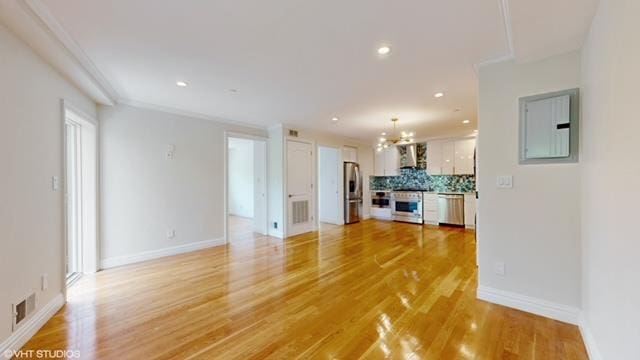 unfurnished living room with recessed lighting, visible vents, baseboards, electric panel, and light wood finished floors