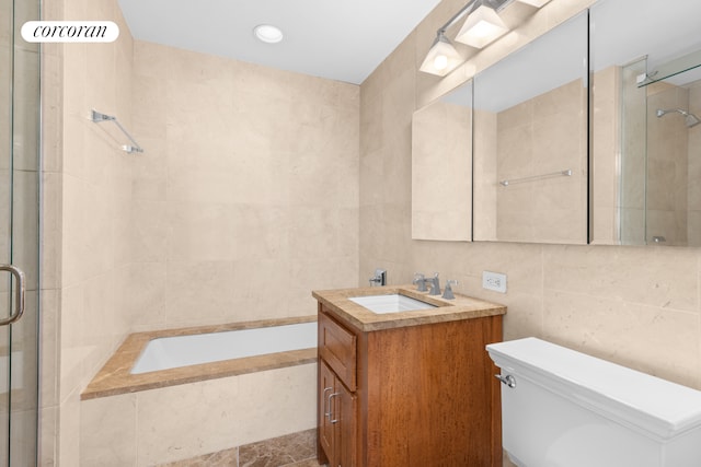 bathroom with tile walls, toilet, vanity, tiled tub, and tiled shower