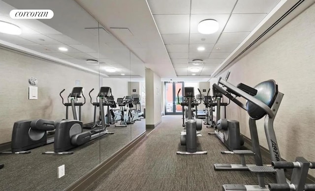 workout area featuring a paneled ceiling and visible vents