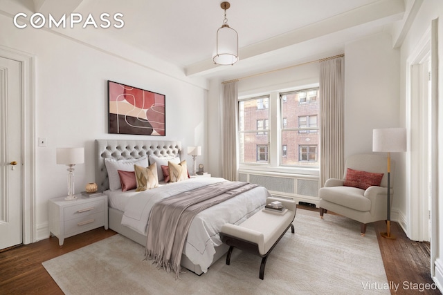 bedroom with baseboards and wood finished floors