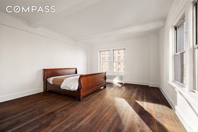 bedroom with beamed ceiling, wood-type flooring, baseboards, and radiator heating unit
