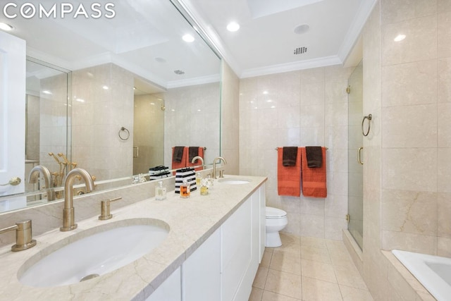 full bathroom featuring tile patterned floors, toilet, crown molding, separate shower and tub, and tile walls