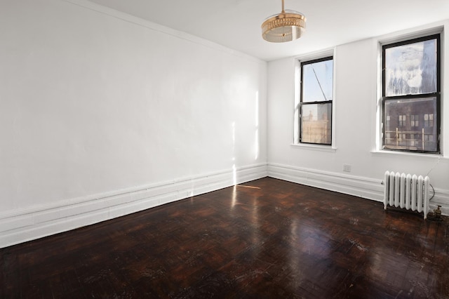 empty room with baseboards and radiator heating unit