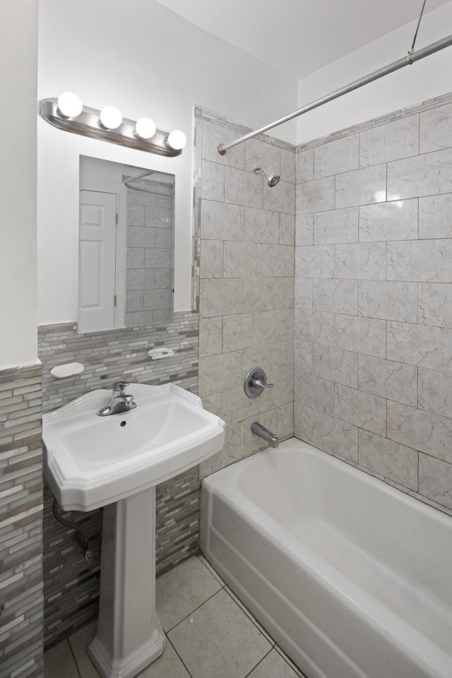 bathroom with a sink, shower / bathing tub combination, tile walls, and tile patterned flooring