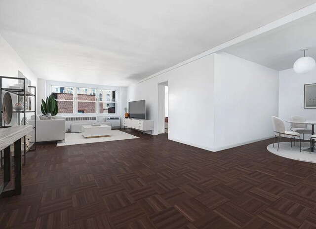 living room with dark parquet flooring and radiator heating unit