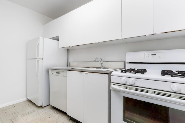 kitchen with white appliances, baseboards, a sink, light countertops, and white cabinets