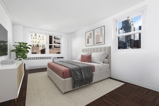 bedroom featuring baseboards and radiator