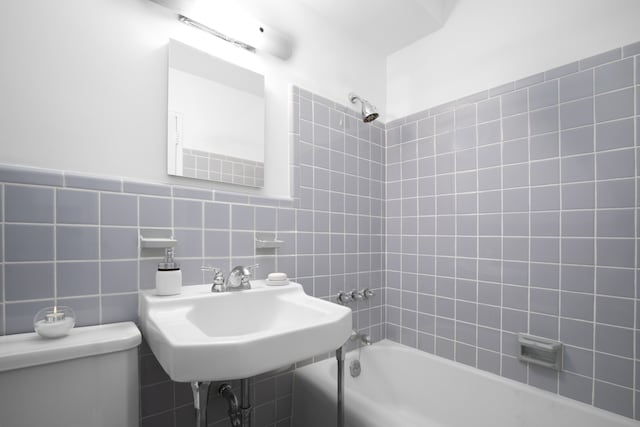 315 E 70th St Unit 7D, New York City, NY 10021 - bathroom featuring bathing tub / shower combination and tile walls