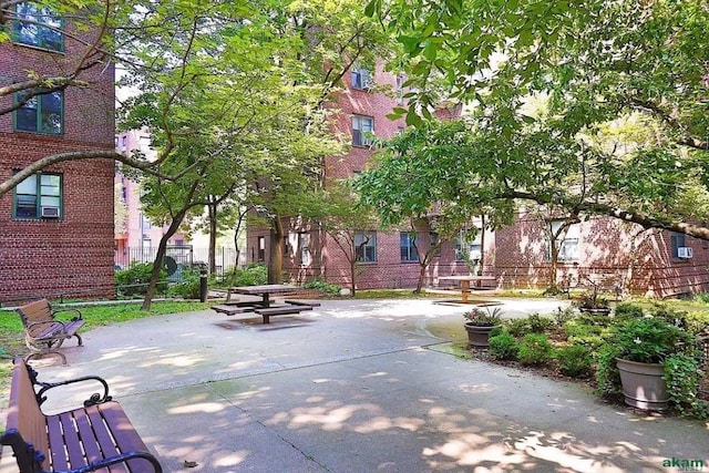 view of home's community with a patio area and fence