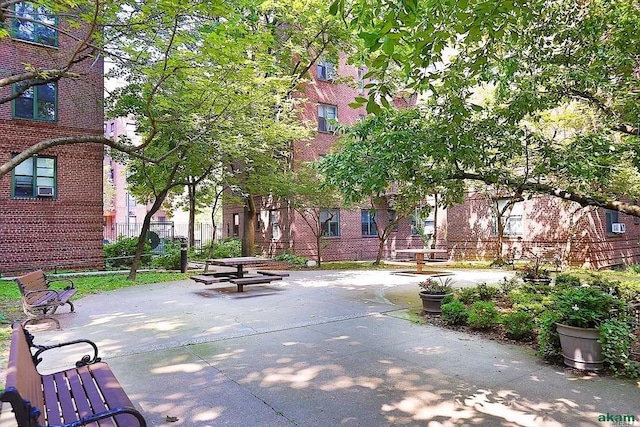 view of home's community with a patio and fence