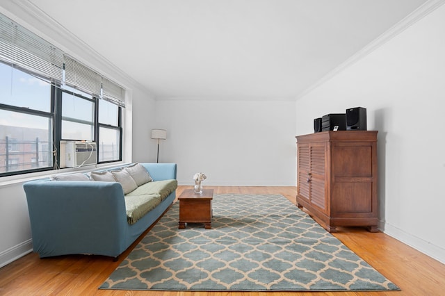 living room with ornamental molding, cooling unit, and wood finished floors